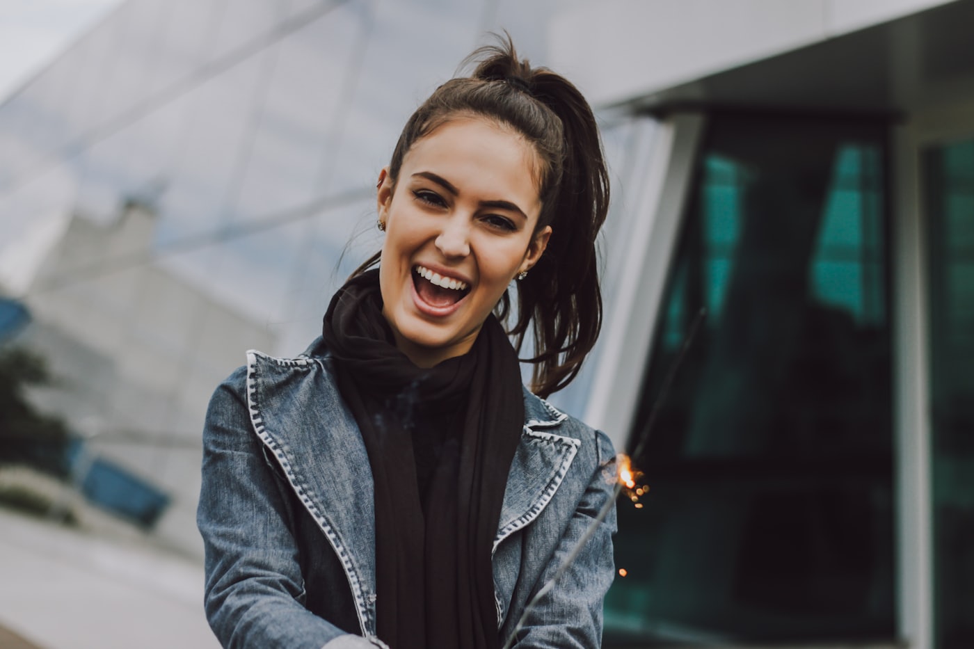 A woman laughing on a city street
